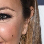 Nicole Lapin on Bravo's "Watch What Happens Live" wearing a Self-Portrait Hazel Lace Mesh Mini Dress with a pair of point-toe Christian Louboutin pumps. She accessorized with gold Pamela Love Five Spike Stud Earrings, a the EF Collection 14k White Gold Pave Gold Diamond X Ring and the sassy Nora Kogan WTF Signet Ring.